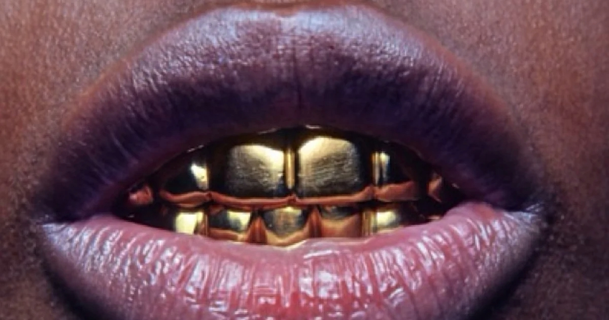black model Grace Jones wearing gold teeth jewelry