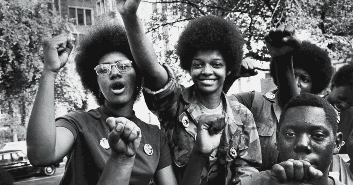 A group of young black people attending a convention for Black Power movement