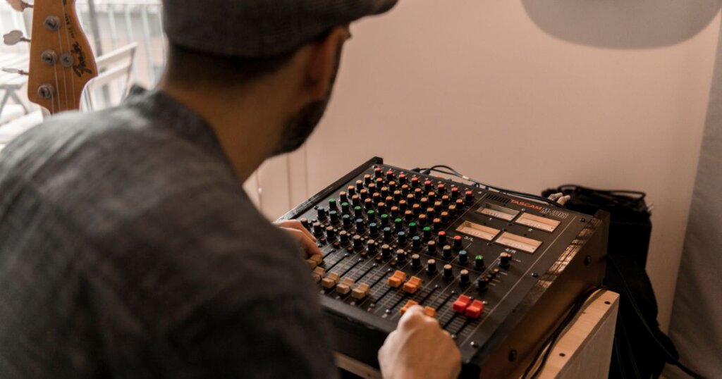 Luzee dubbing tracks on a Tascam analogue mixer for Afrosketches album